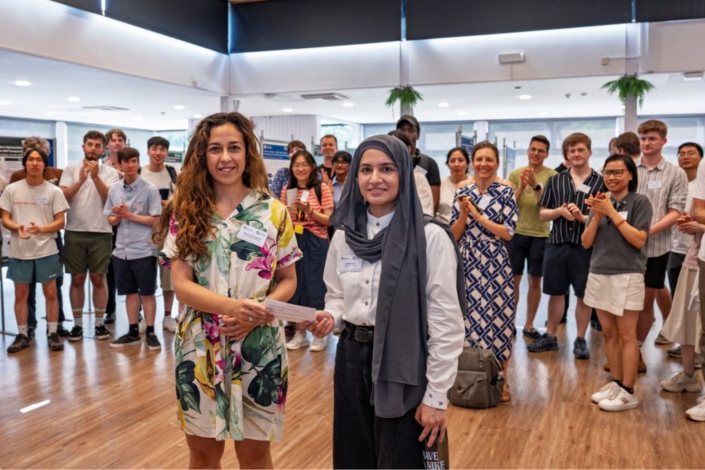 Nehal Yasin receiving the MINDS poster prize at the 2026 MINDS and SustAI Showcase